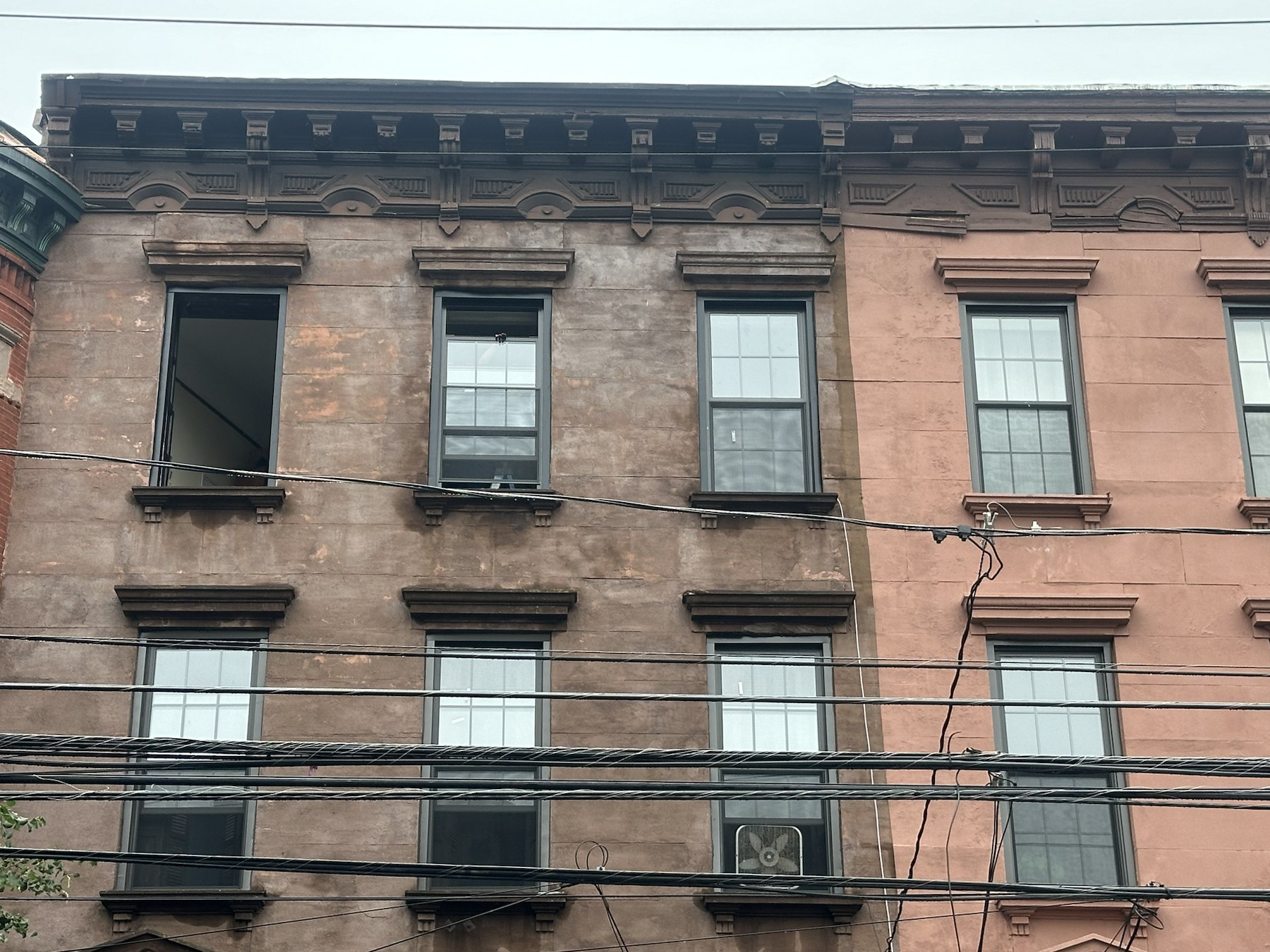 New windows installed across a New Jersey rowhouse facade